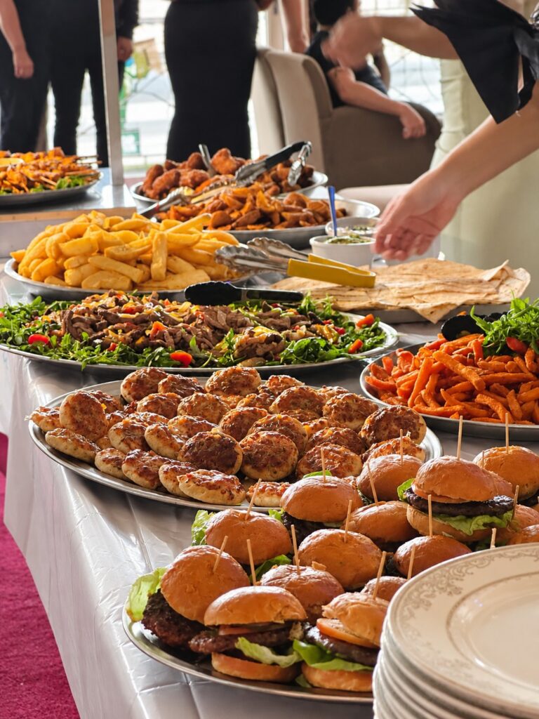 Buffet spread for a function at Marina Metro Hotel, with sliders, fries, salads and platters